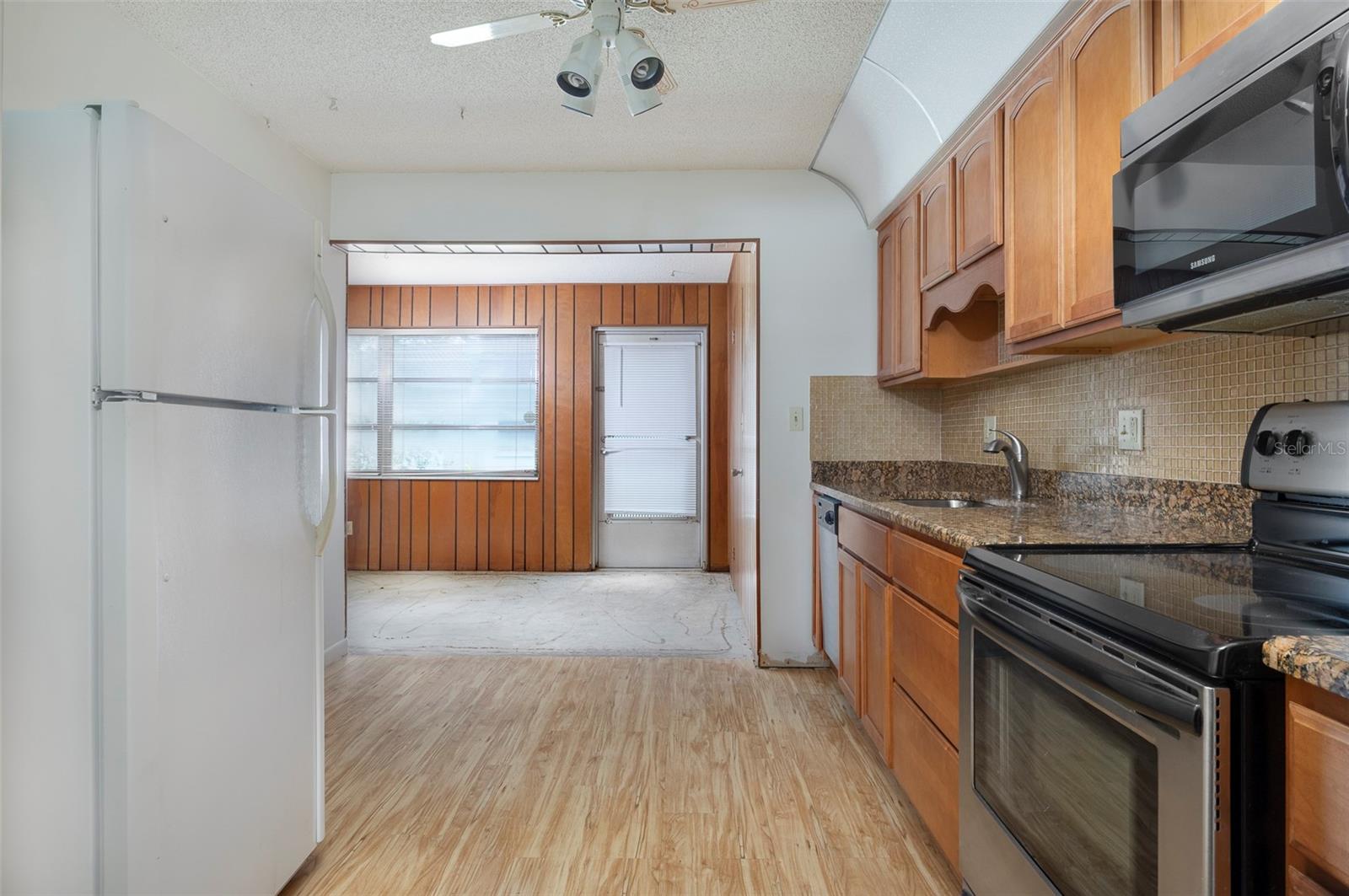 Kitchen has any area for a small table. Newer applainces, wood cabinets and granite countertops