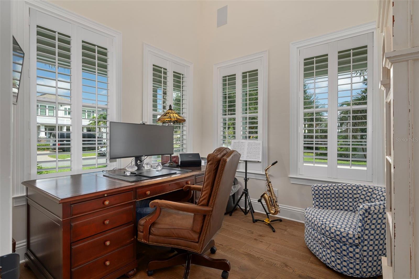 Private home office with glass French doors and a closet.