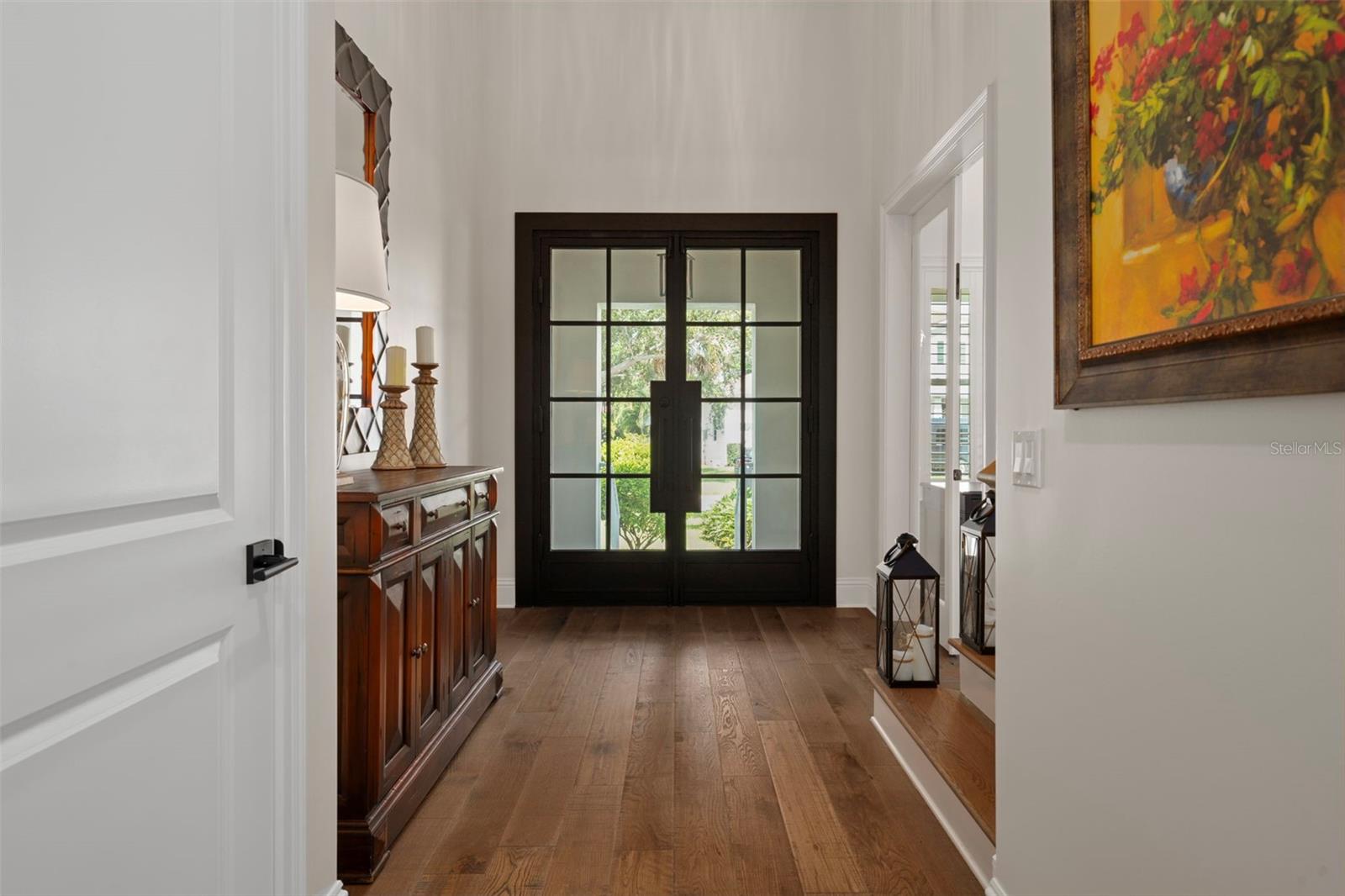 Welcoming foyer entry.  to the left is the powder bathroom. To the right is the office and the stairs to head to the second level.