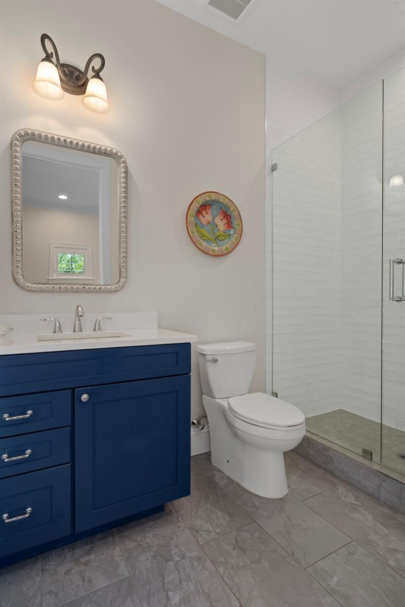 Guest bath with walk-in shower & designer vanity. This bathroom can also serve as a pool bath.
