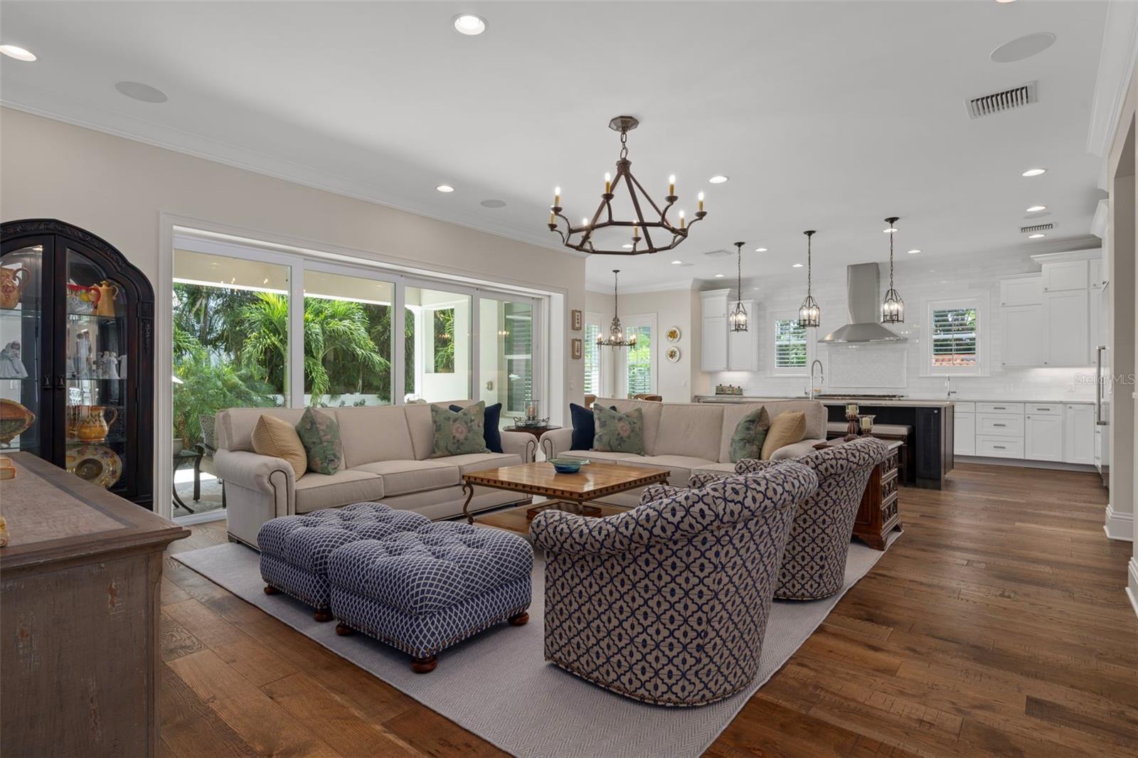 Open-concept living & dining space with lots of natural light and big sliders that lead to the covered patio.