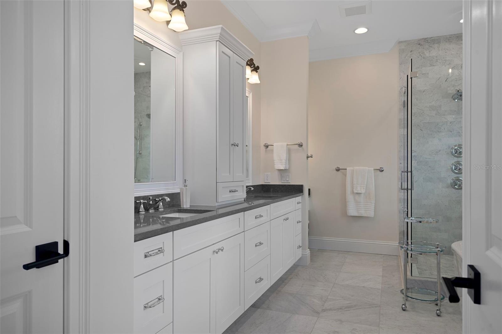 Spa-style primary bath with dual vanities & walk-in shower