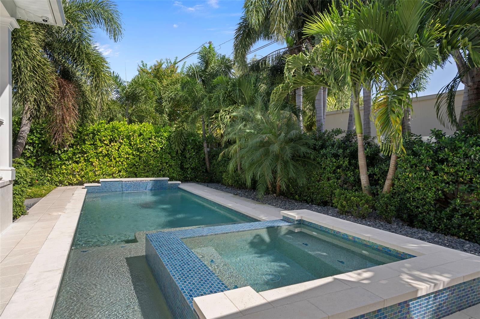 Backyard oasis surrounded by lush landscaping providing privacy