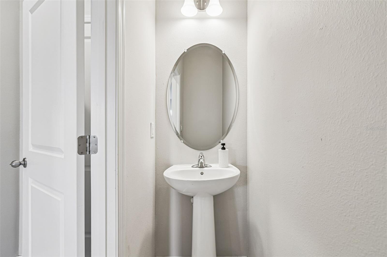 Half bath on first floor with pedestal sink