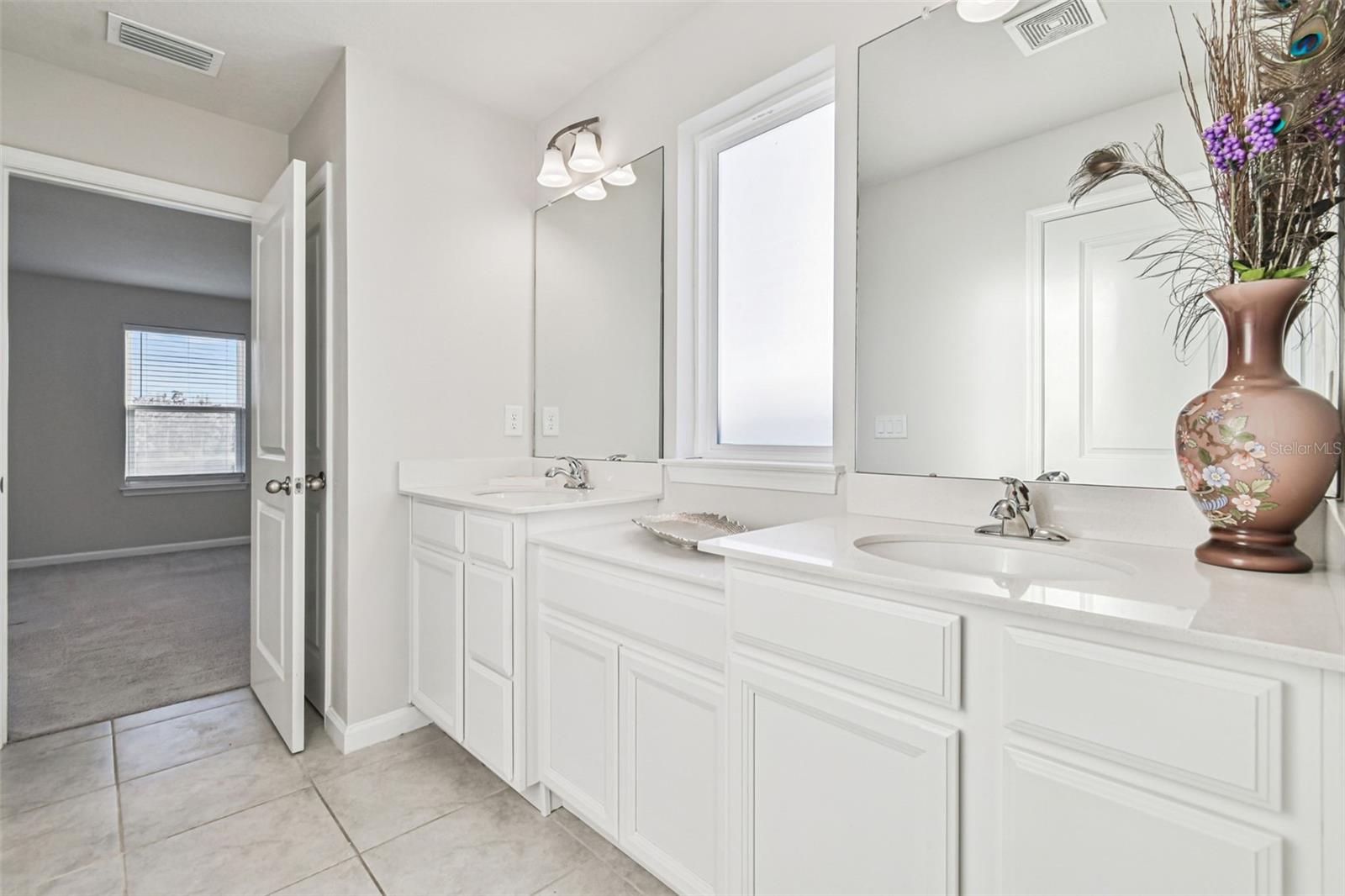 Dual sinks with ample counter space in primary bathroom