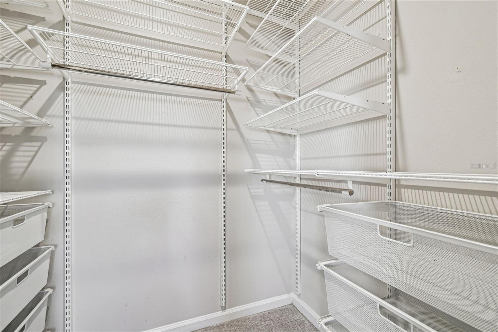 Great organizational shelving system in primary bedroom closet
