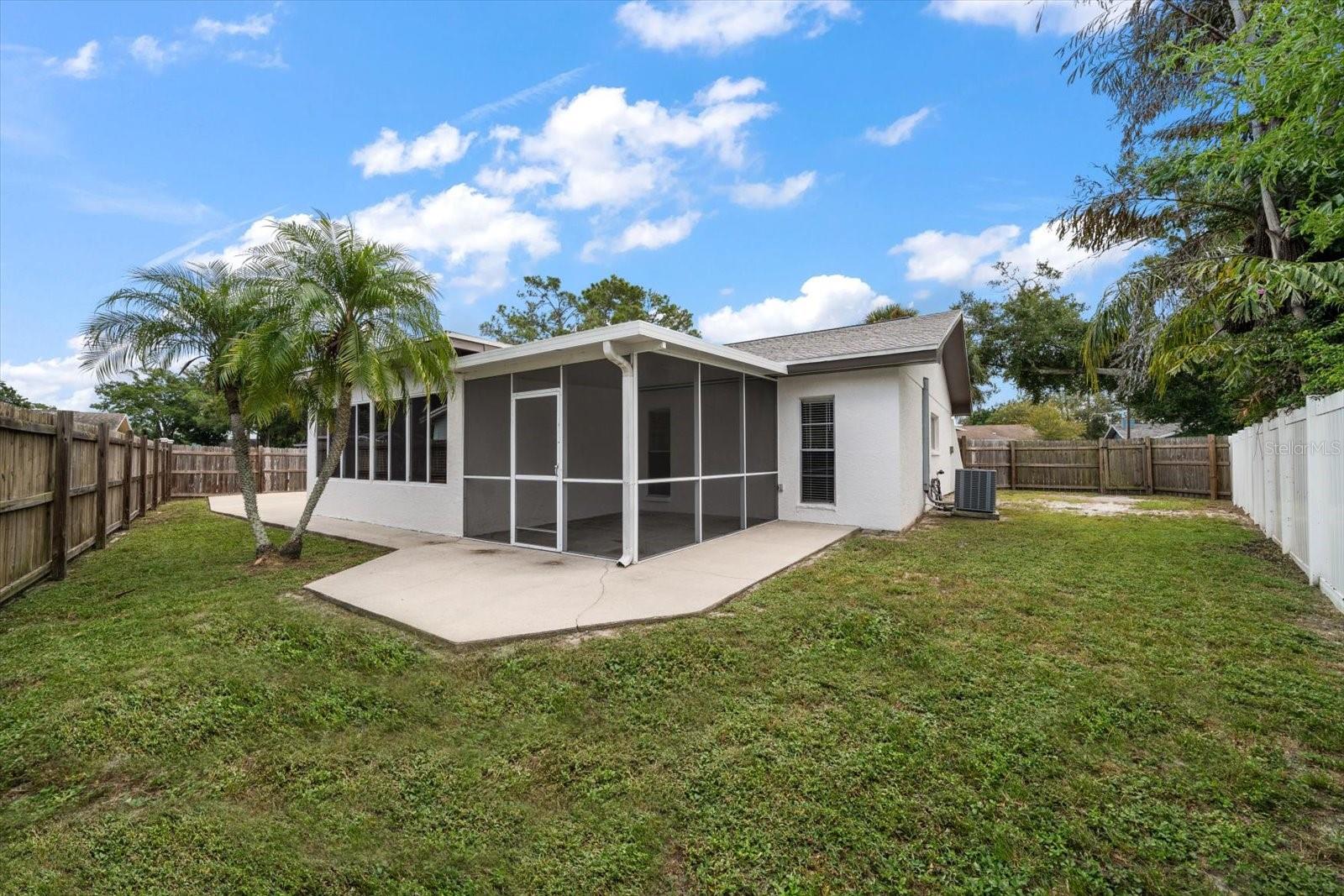 Backyard with screened in patio