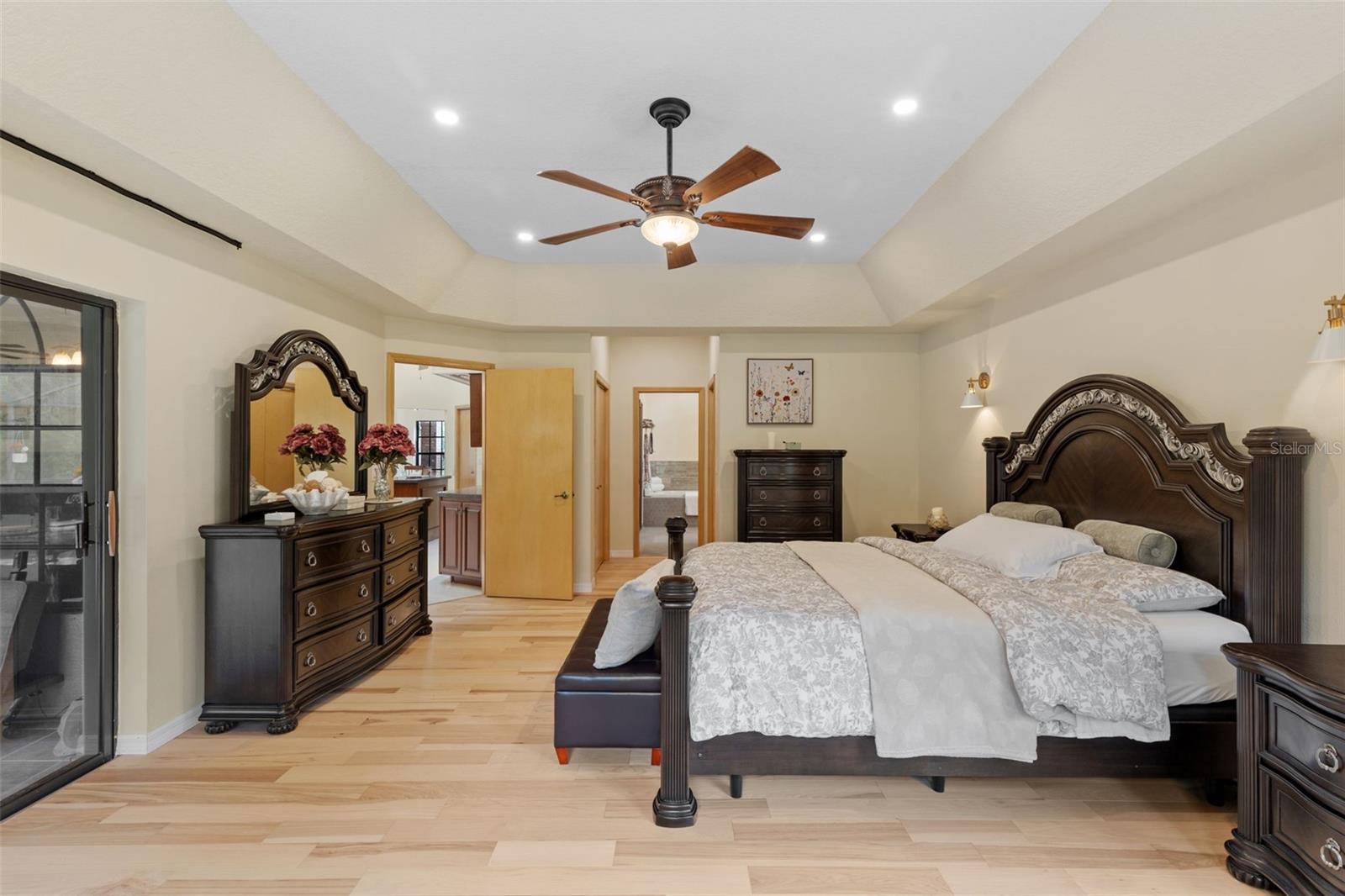 Spa-inspired primary suite awaits you just beyond his and hers closets.
