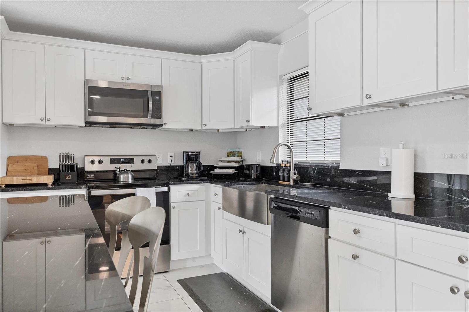 Remodeled in 2023 with shaker style cabinets and granite counters this kitchen comes fully equipped!