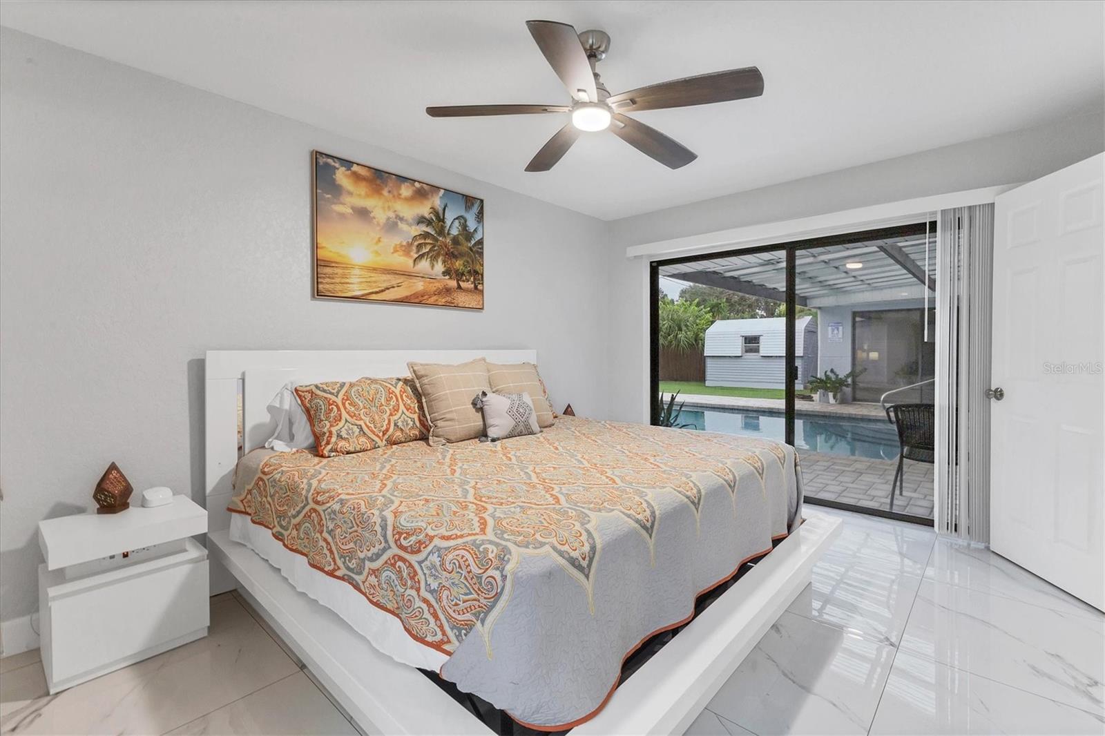 Bedroom 3 on the opposite of bedroom 2 also has a view of and access to the pool/patio and backyard.