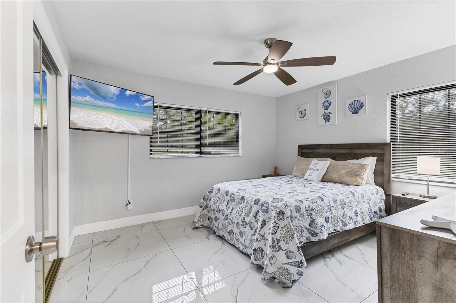 Bedroom 4 features a wall mounted TV and ceiling fan.
