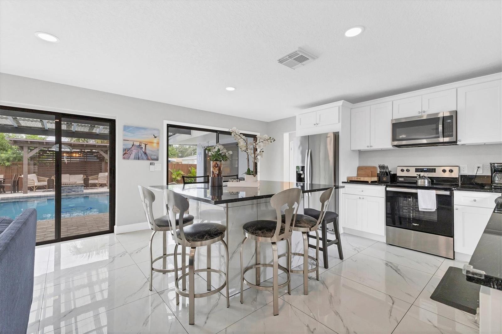 And open kitchen/dining to the right with doors to patio