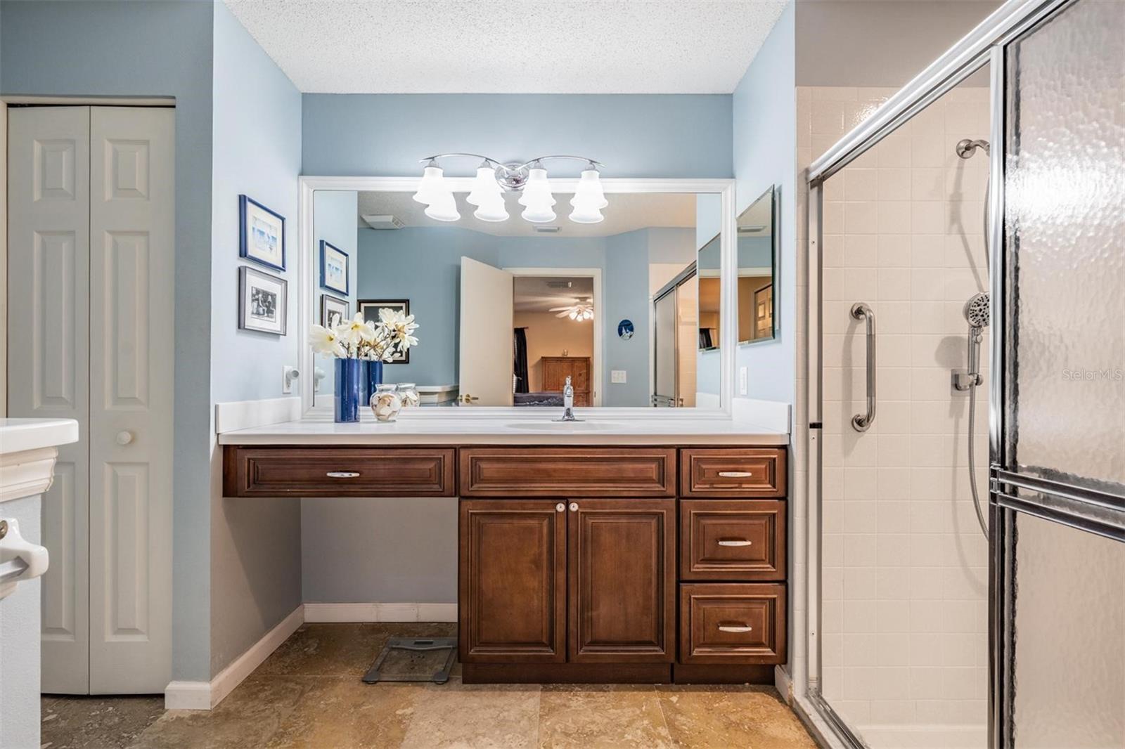 Master bath with vanity seating and step-in shower