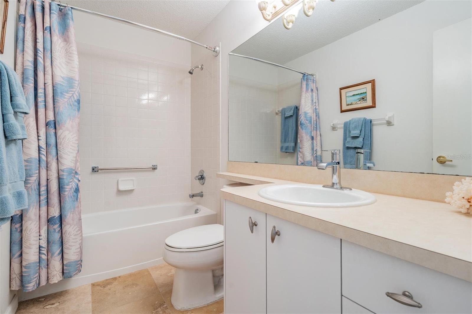 Travertine flooring in the secondary bathroom