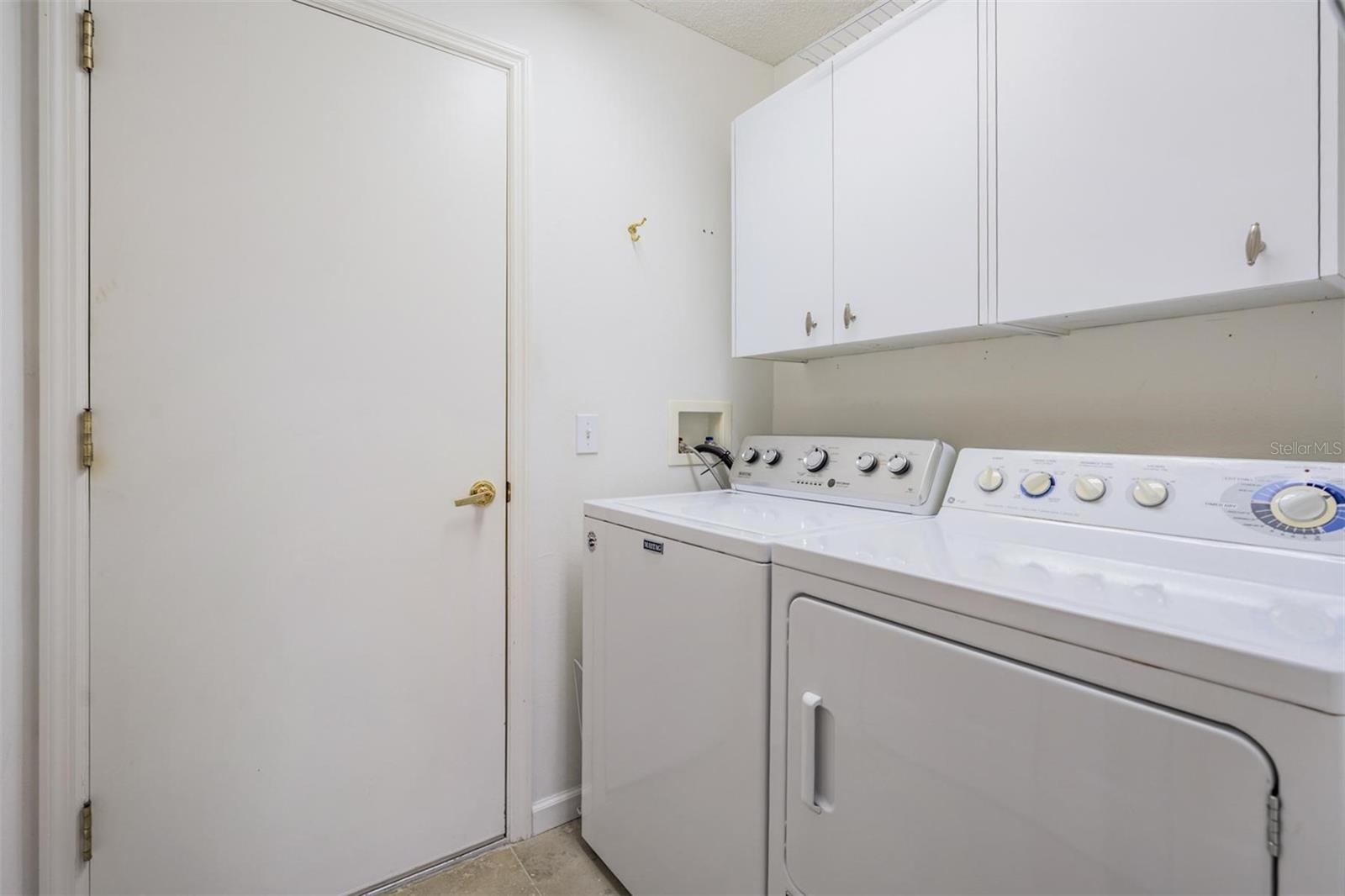 Inside laundry room with built-in storage