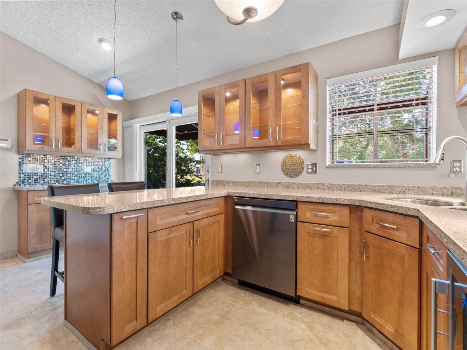 Beautifully updated kitchen with quartz countertops, and Craftmade cabinetry — a chef’s dream!