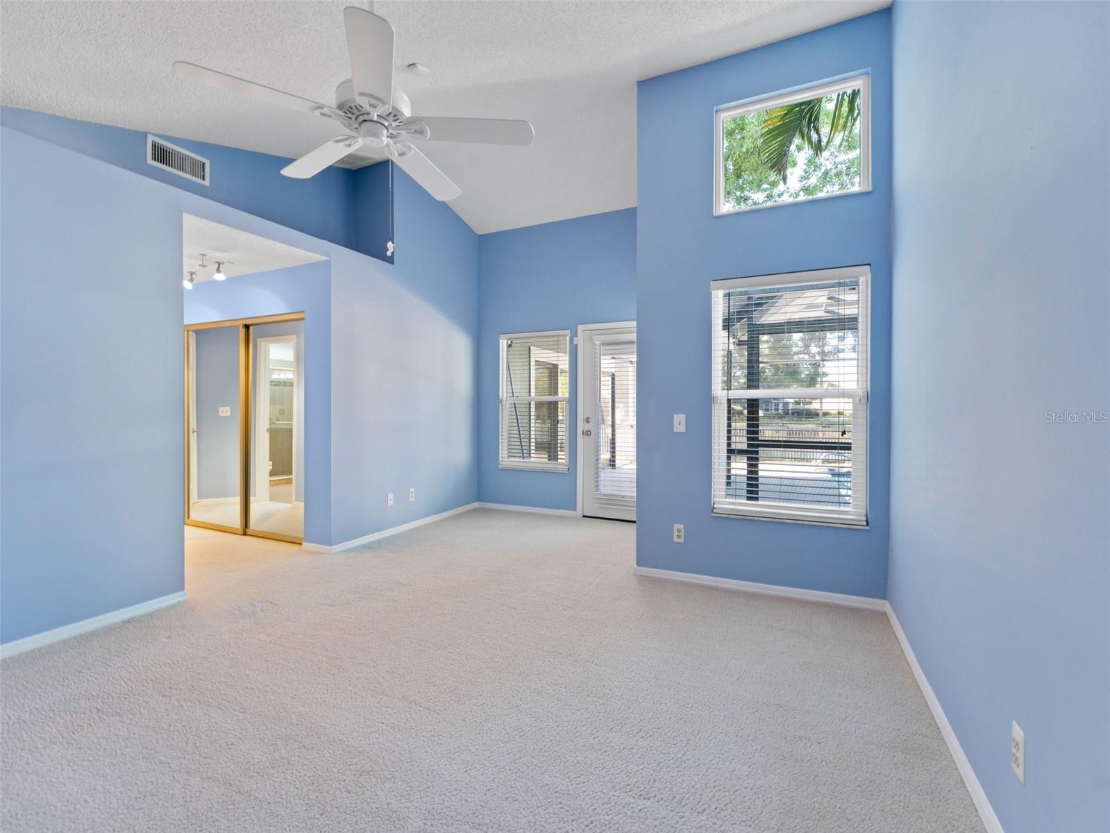 Primary bedroom with vaulted ceilings and plenty of space for all your furniture — a luxurious and airy retreat