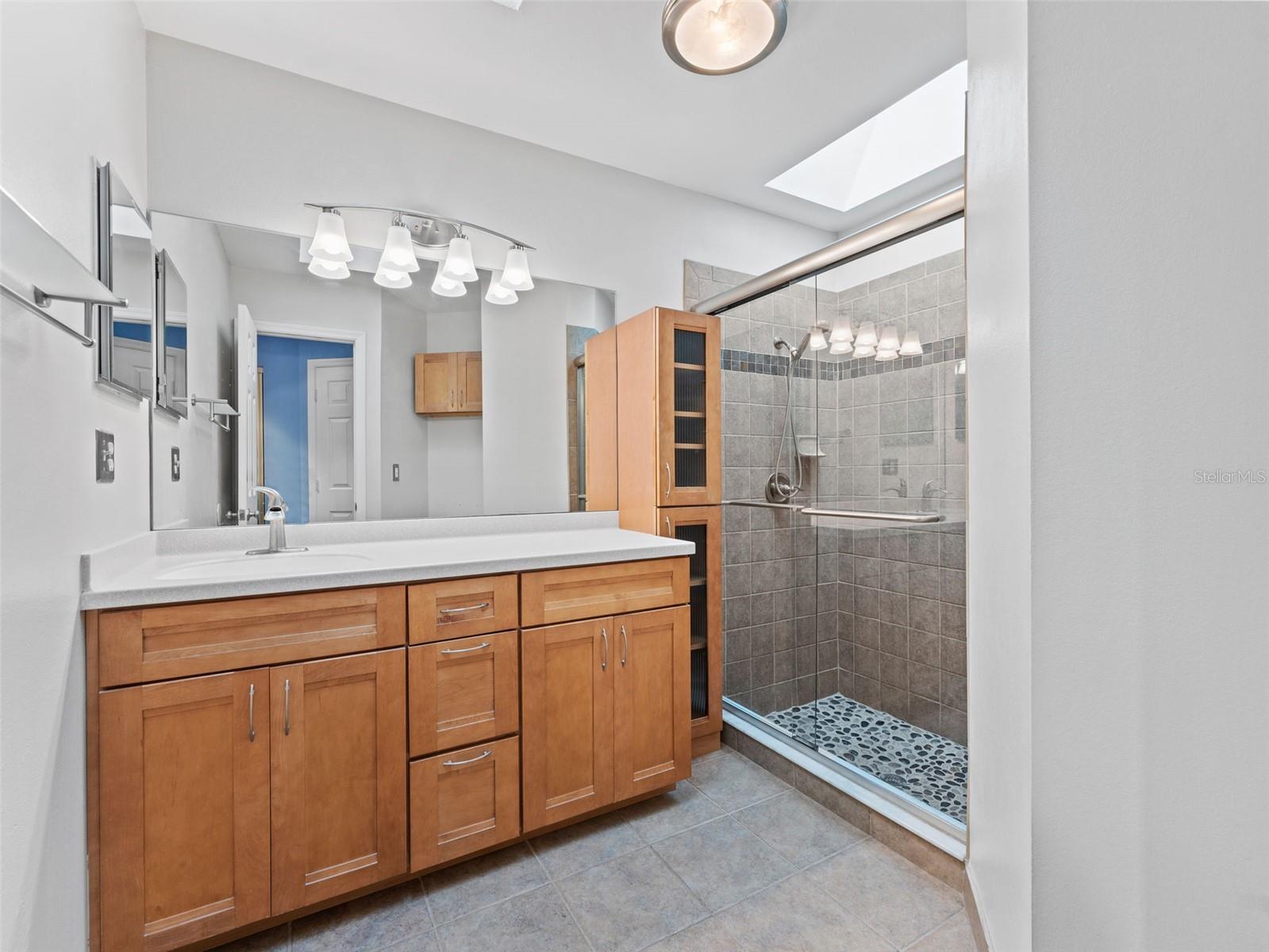 Elegant ensuite bathroom featuring an oversized vanity, walk-in shower, and extra storage — a spa-like retreat in your own home