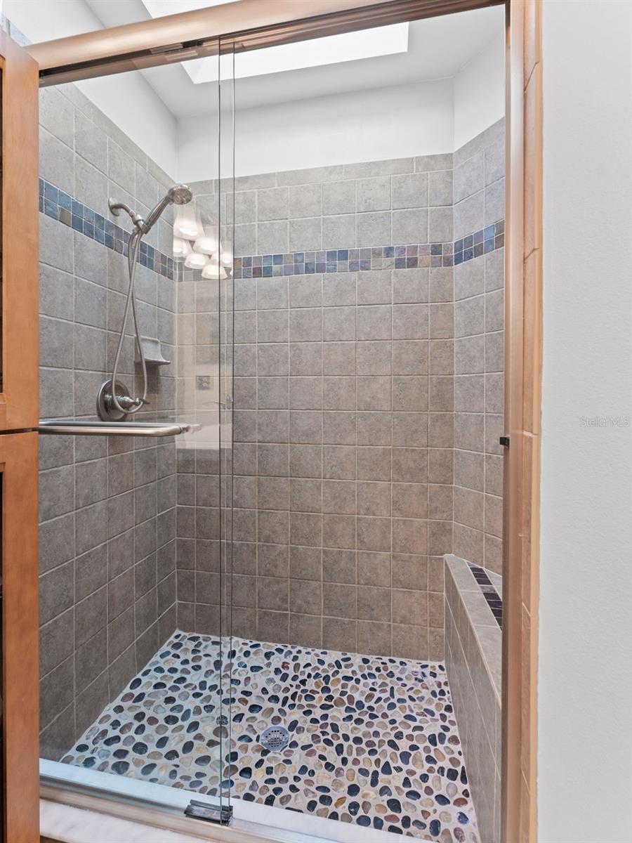 Beautiful walk-in shower with a skylight, filling the space with natural light for a bright and relaxing experience
