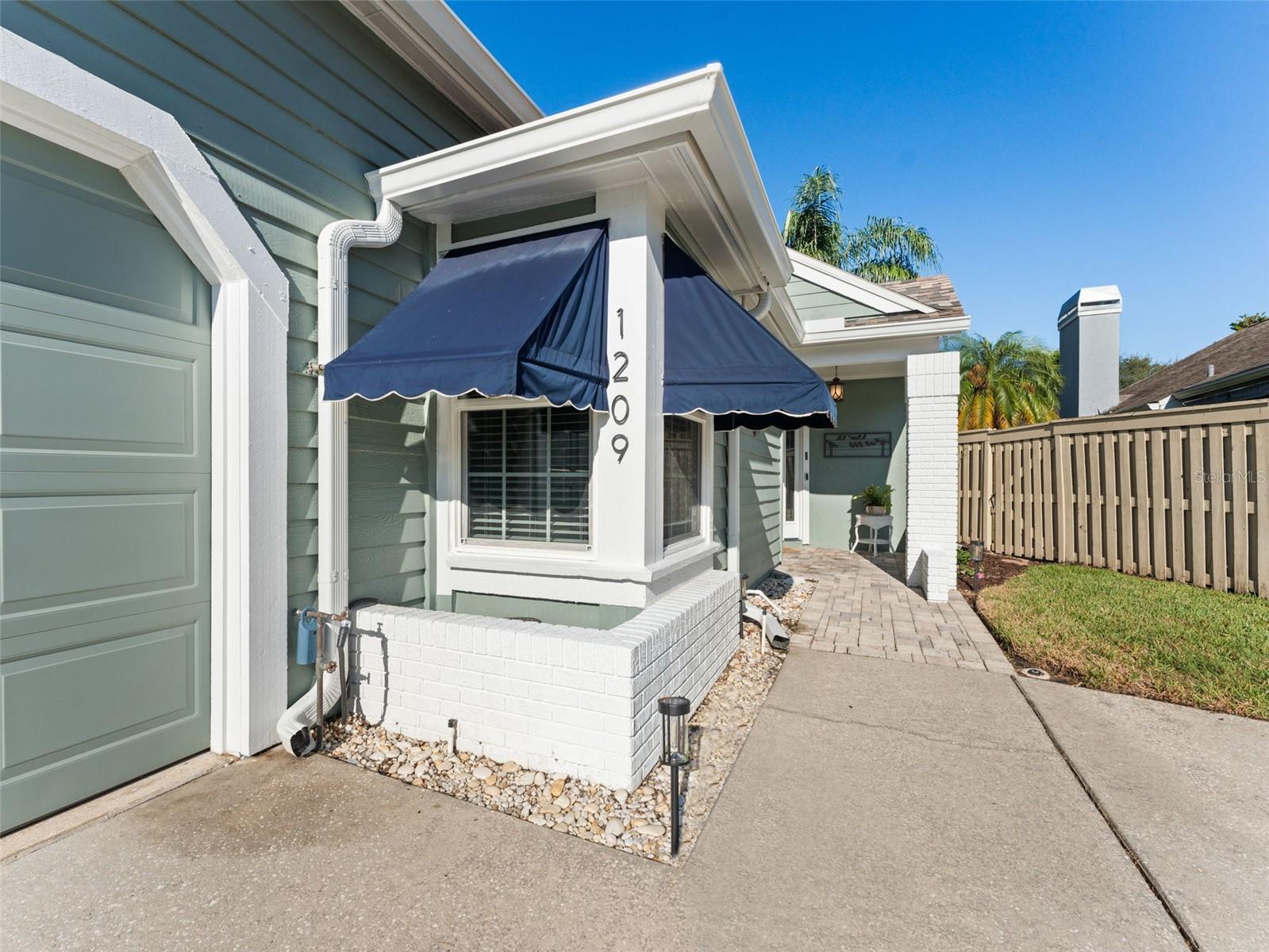 Charming walkway leads you to the front door, setting the tone for the warm and welcoming feel of this home