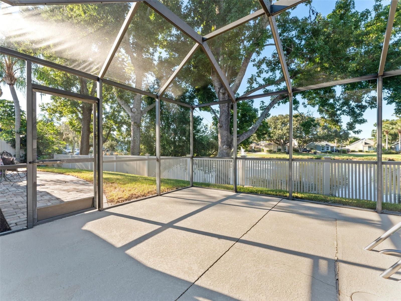 Extended pool deck with serene pond views — enjoy privacy and peaceful outdoor living