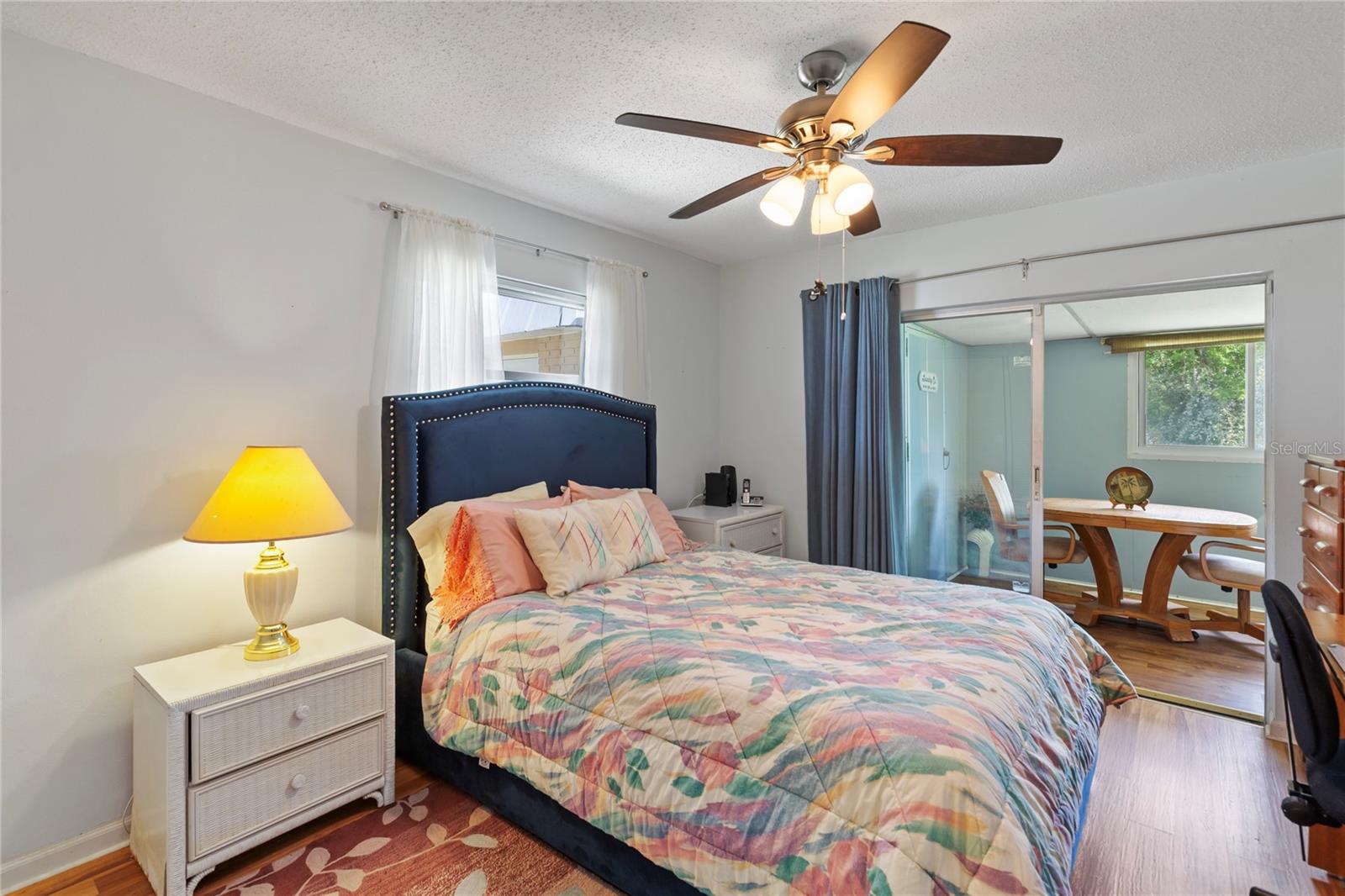 Secondary bedroom with sliders to the Florida room/Lanai and Laundry