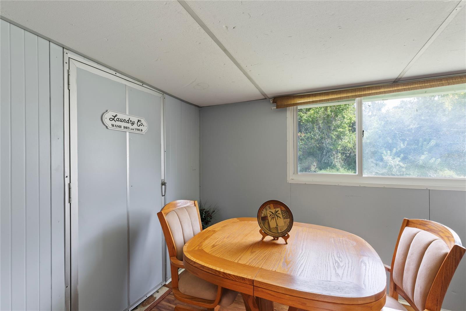 Florida room/Lanai with laundry and door to backyard