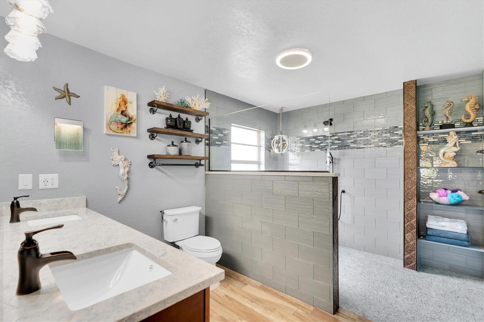 En-suite bath features double-sinks and walk-in shower