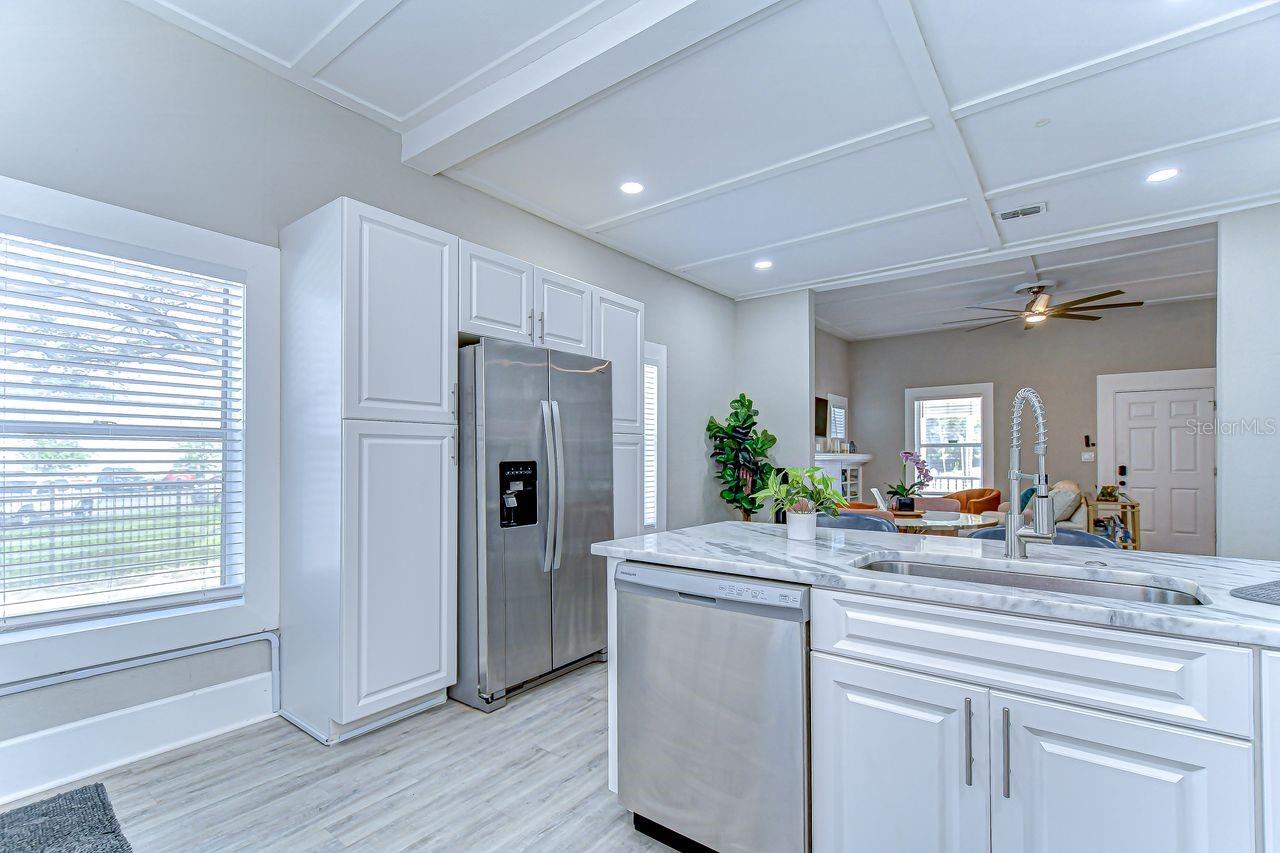 This kitchen offers abundant storage with tall cabinetry and stainless steel appliances