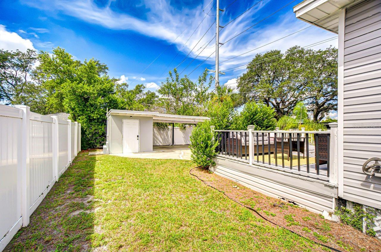 The fenced backyard offers both privacy and space, complete with a deck for outdoor entertaining. A versatile carport with storage adds extra convenience to this charming property.