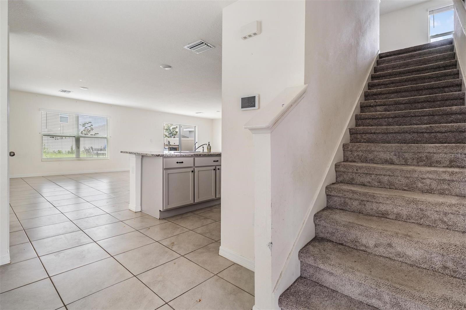 from foyer area, stairs up and kitchen and great room