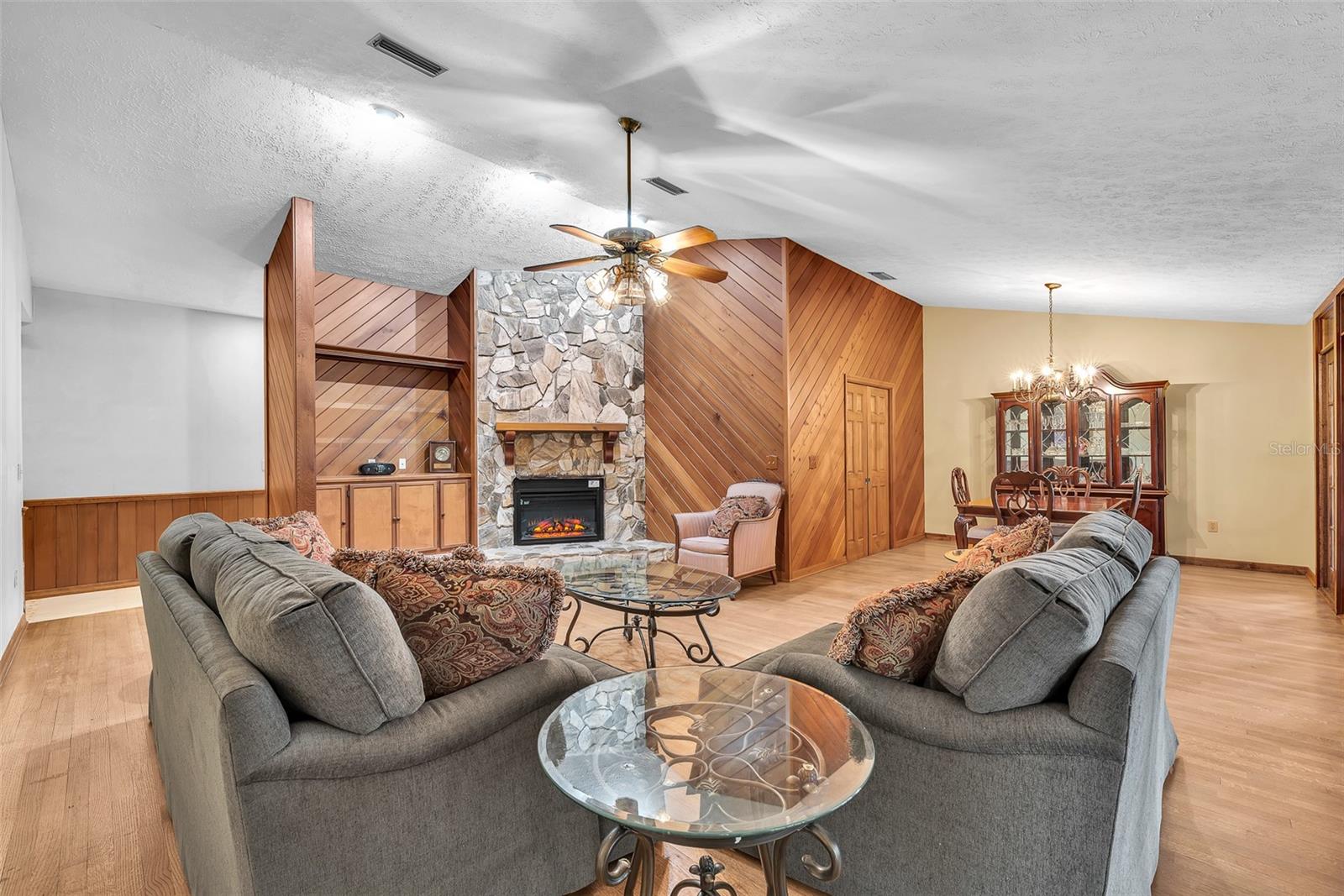 Cozy beside the wood burning fireplace which currently has an electric remote-controlled insert.  Buyer can choose which way to enjoy the fire.