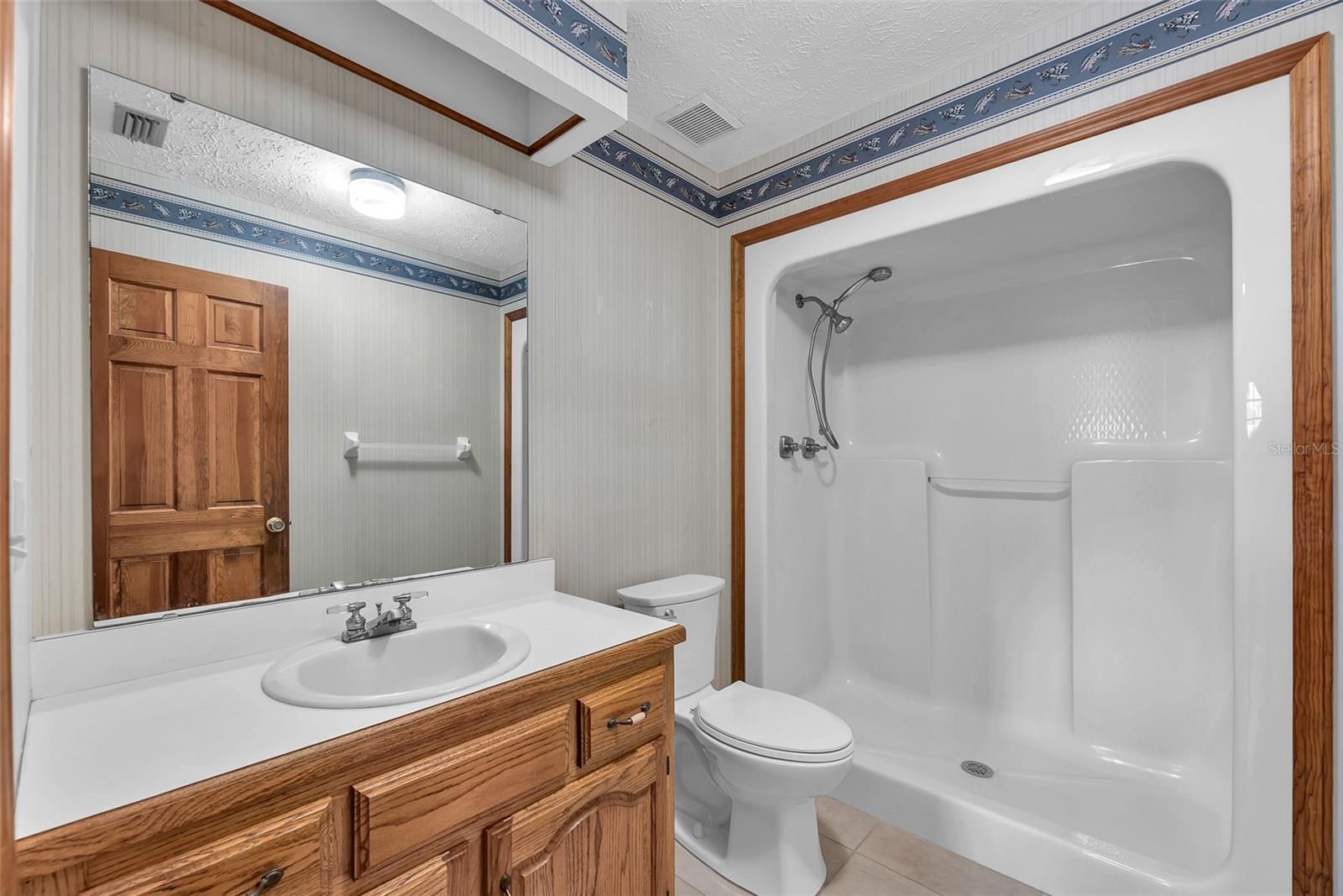 Bathroom #3 just off the mud room/laundry has a Step in Shower, toilet and vanity with sink.
