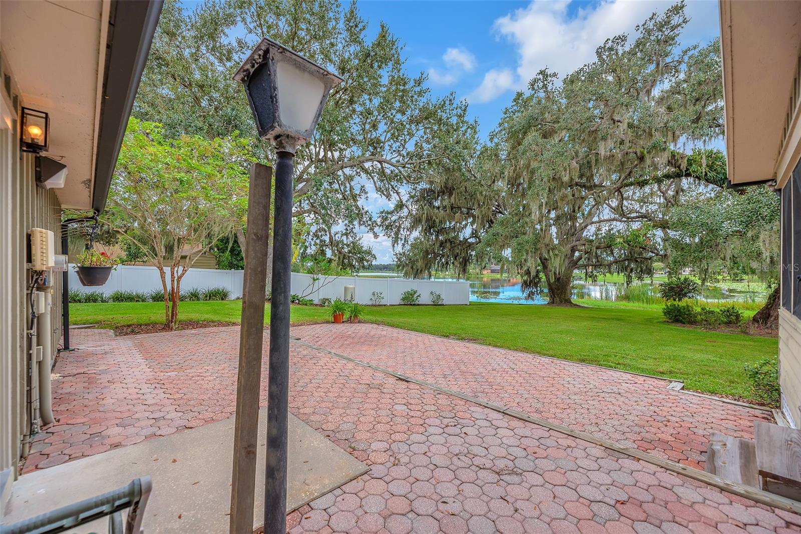 A spacious patio, located just off the garage side door and back porch, offers a peaceful setting to watch birds as they gather along the natural shoreline of Long Pond Lake.