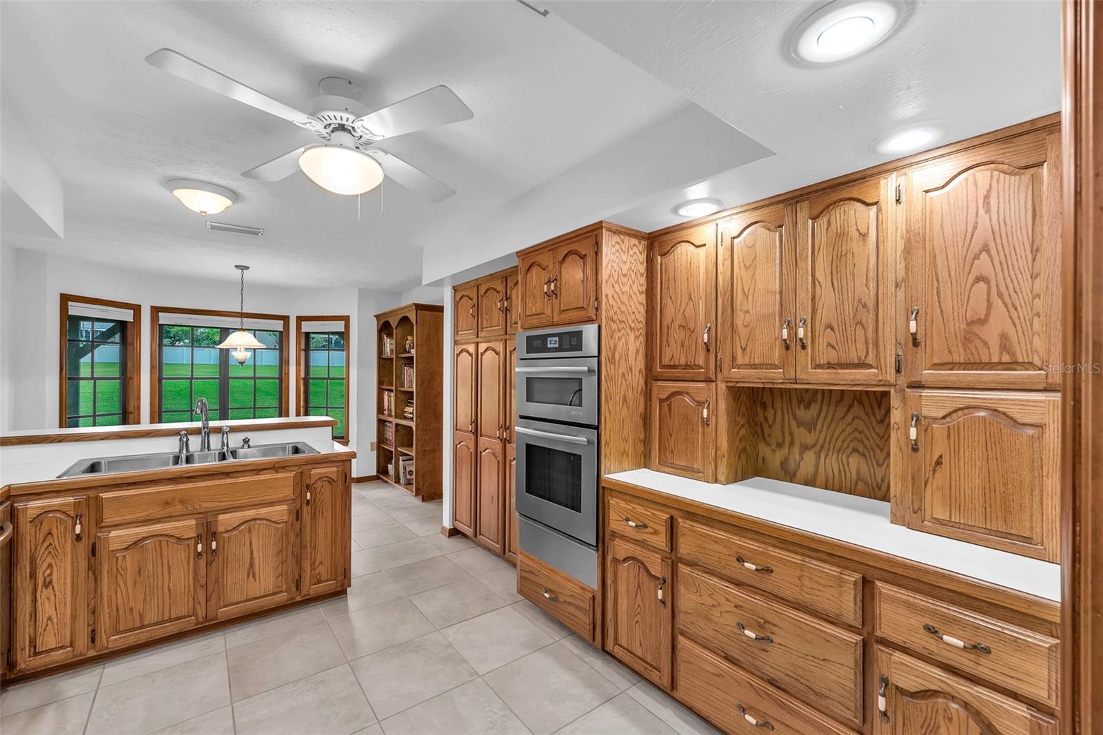 High-end Jenn-Air appliances, including a wall oven/microwave combo and cooktop, elevate the cooking experience