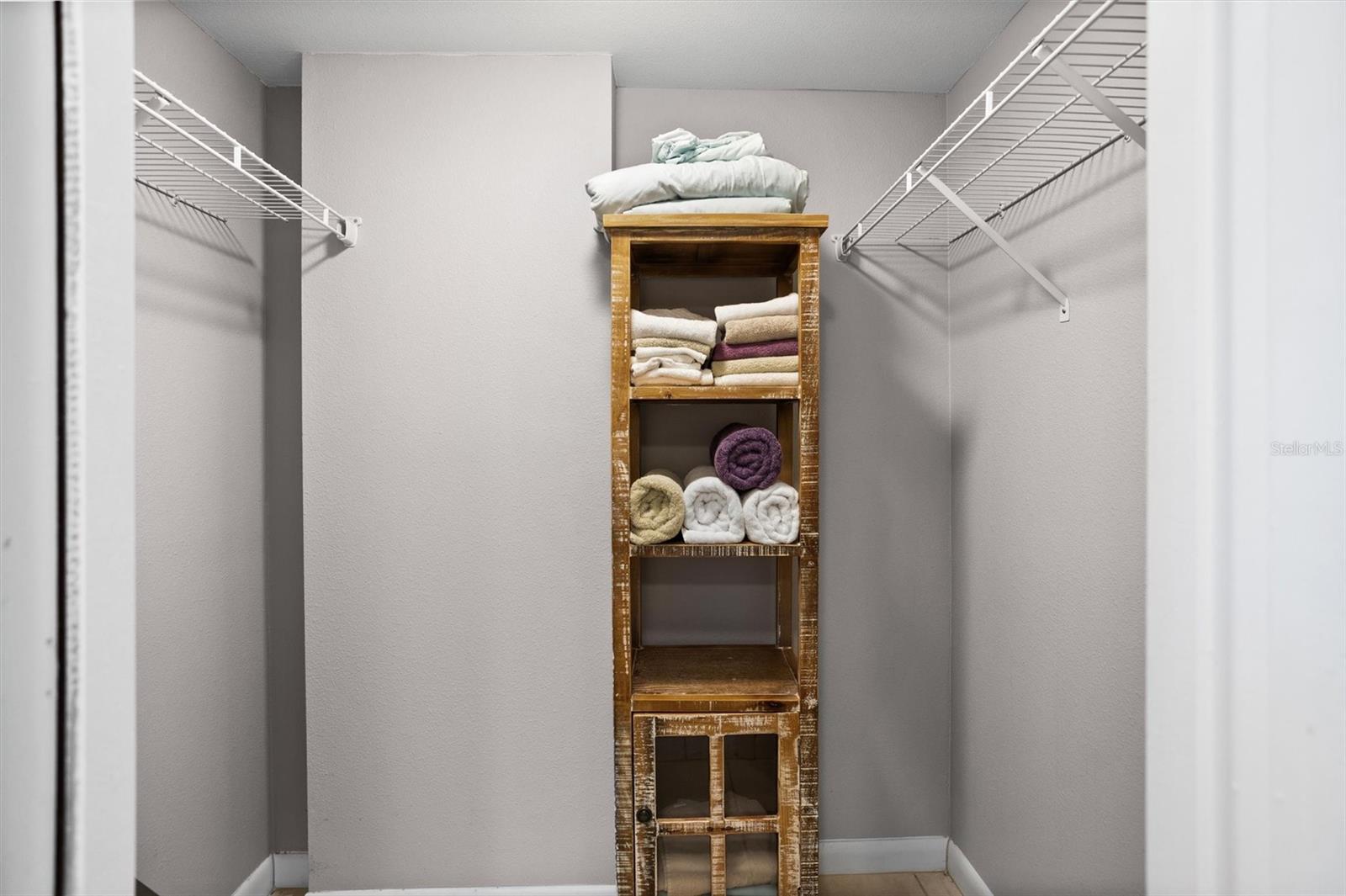 One of two primary walk in closets