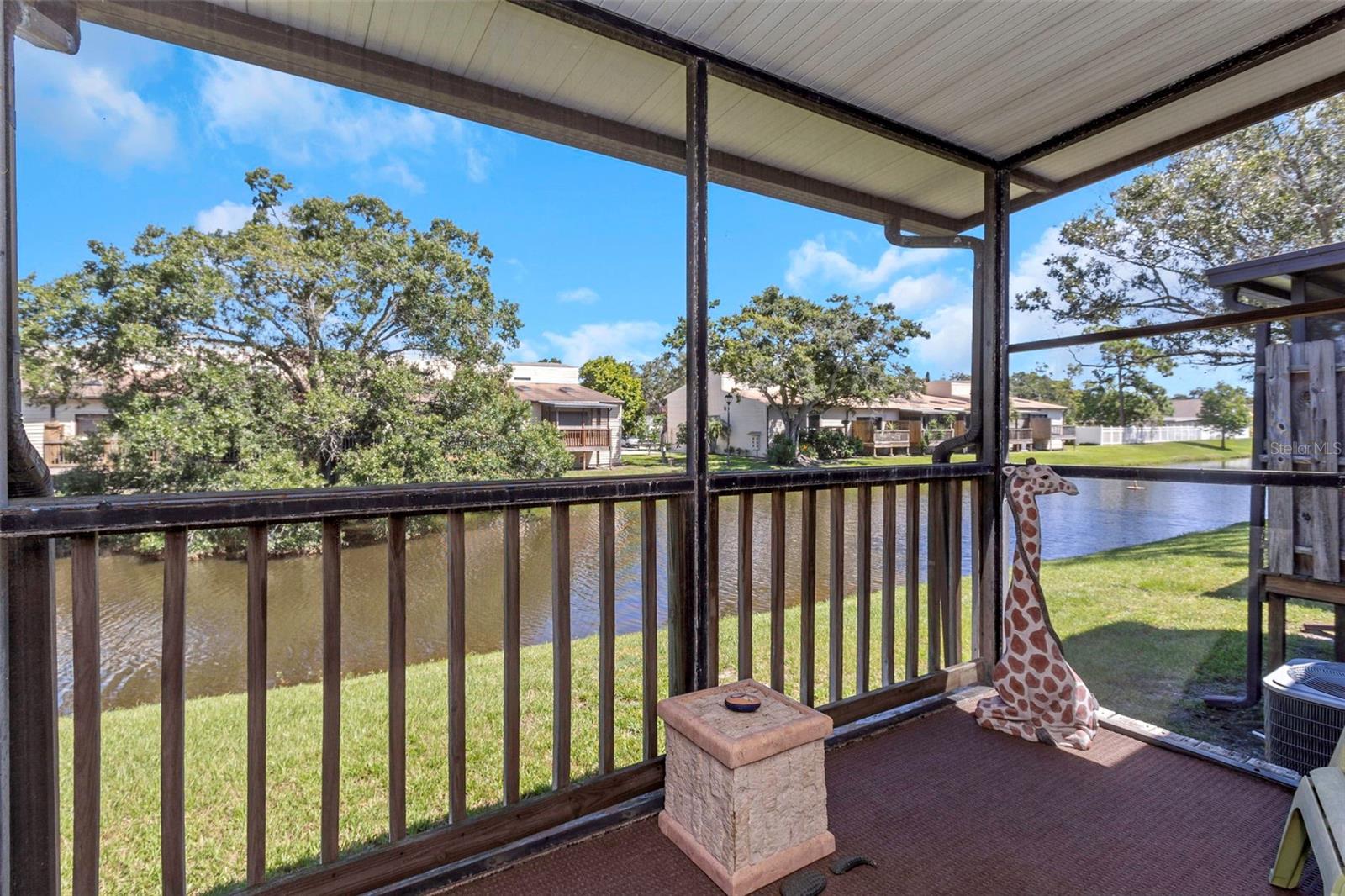 Screen enclosed rear porch with beautiful lake view.