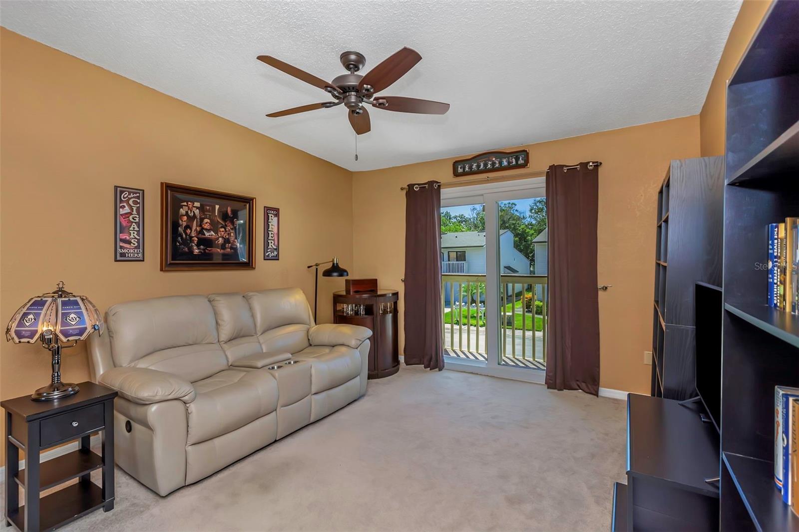Second bedroom with built-in closet and exterior balcony.