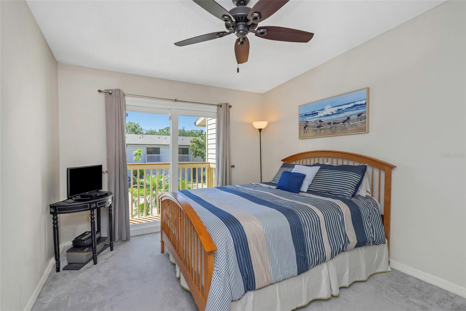 Third bedroom with built-in closet and exterior balcony.