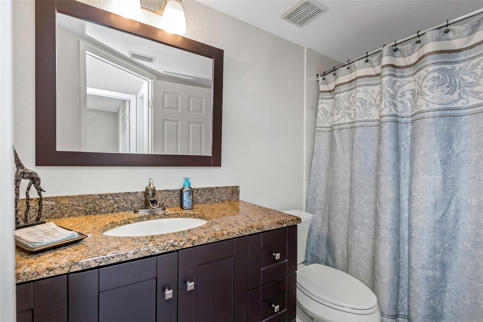 Guest bathroom with tub/shower combination.