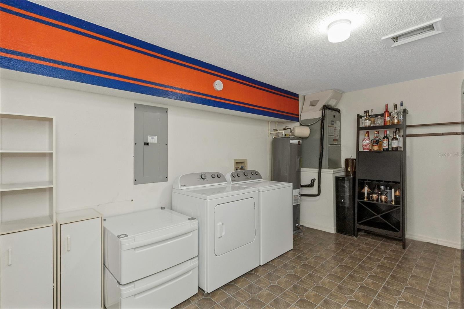 Laundry room complete with newer (2024) washer & dryer and secondary refrigerator (2022).