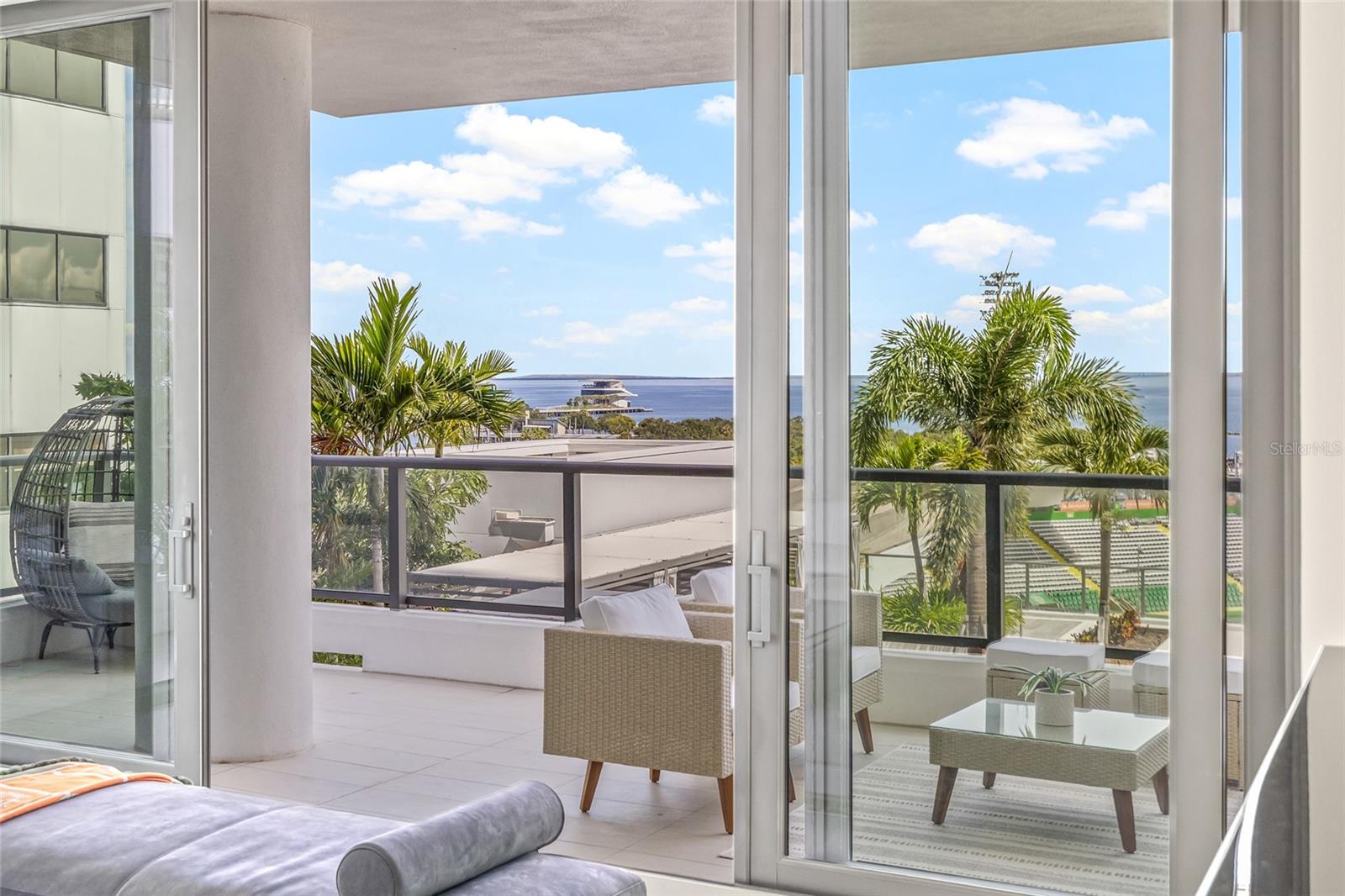 Step outside onto the expansive private terrace—among the largest in the building—where you can enjoy views of the waterfront, marina, pool, and city skyline.