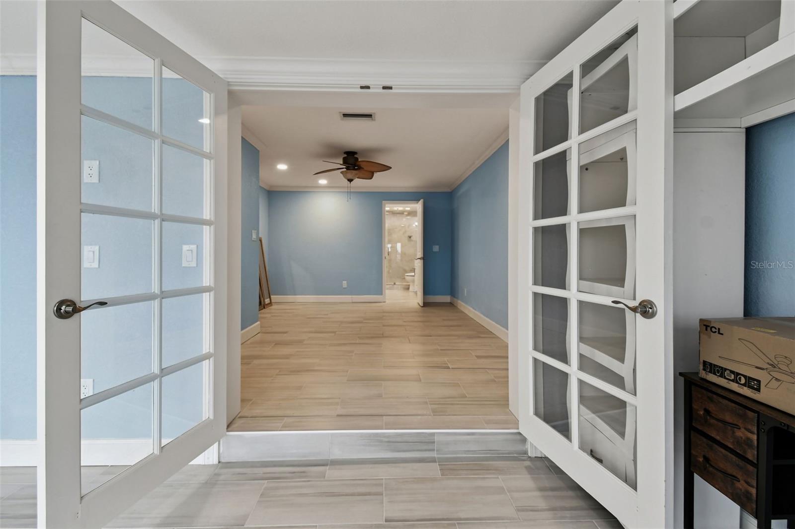 French doors leading to primary bedroom with ensuite bathroom.