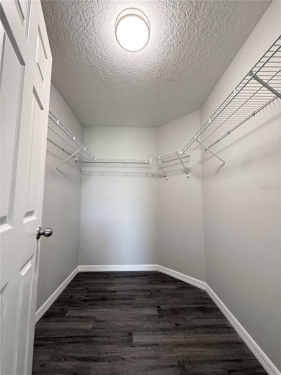 Primary bedroom walk-in closet