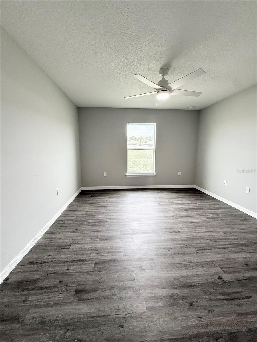 Spacious primary bedroom with oversized walk-in closet
