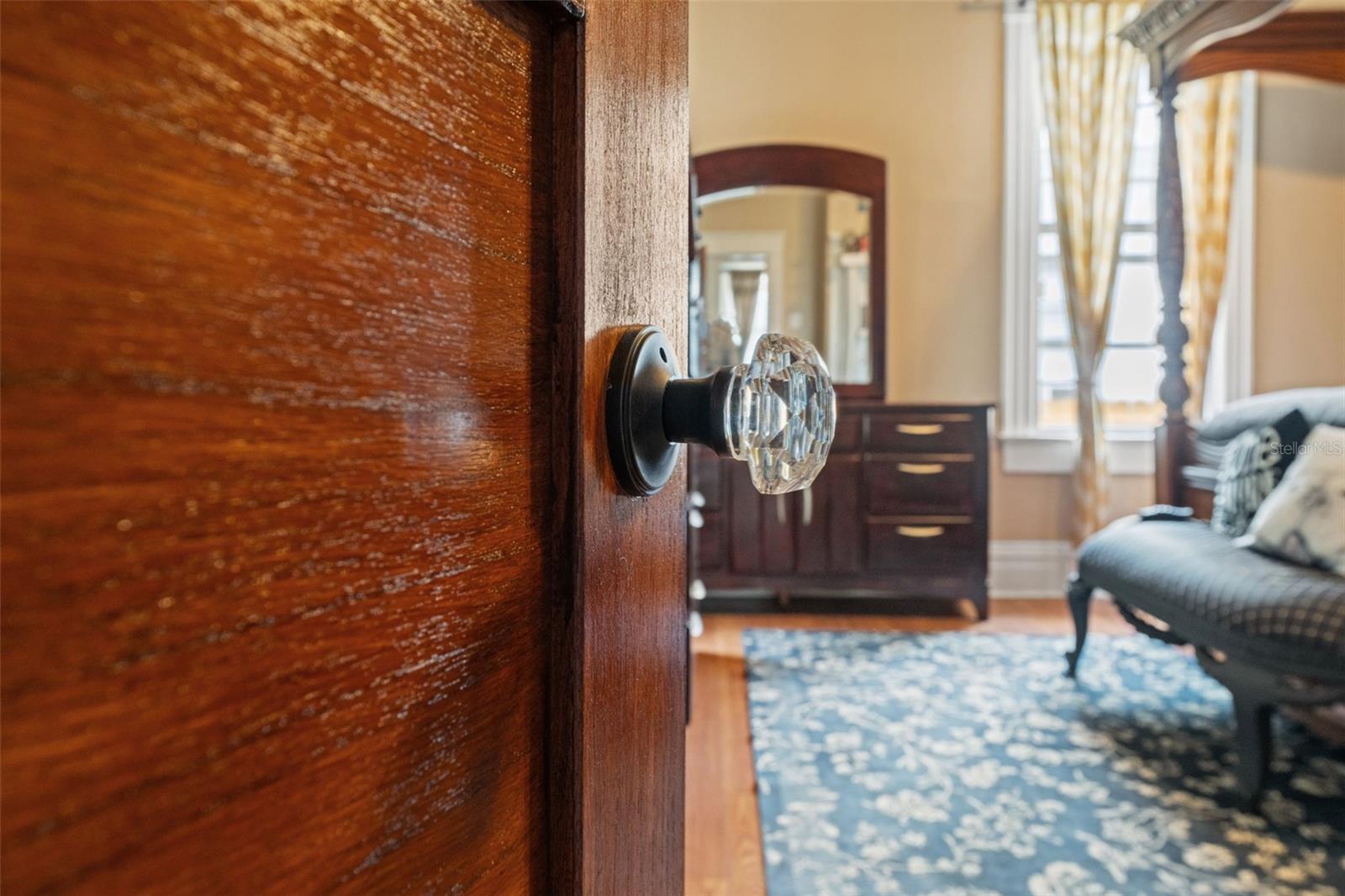 Custom Wood Doors with Glass Doorknobs Throughout