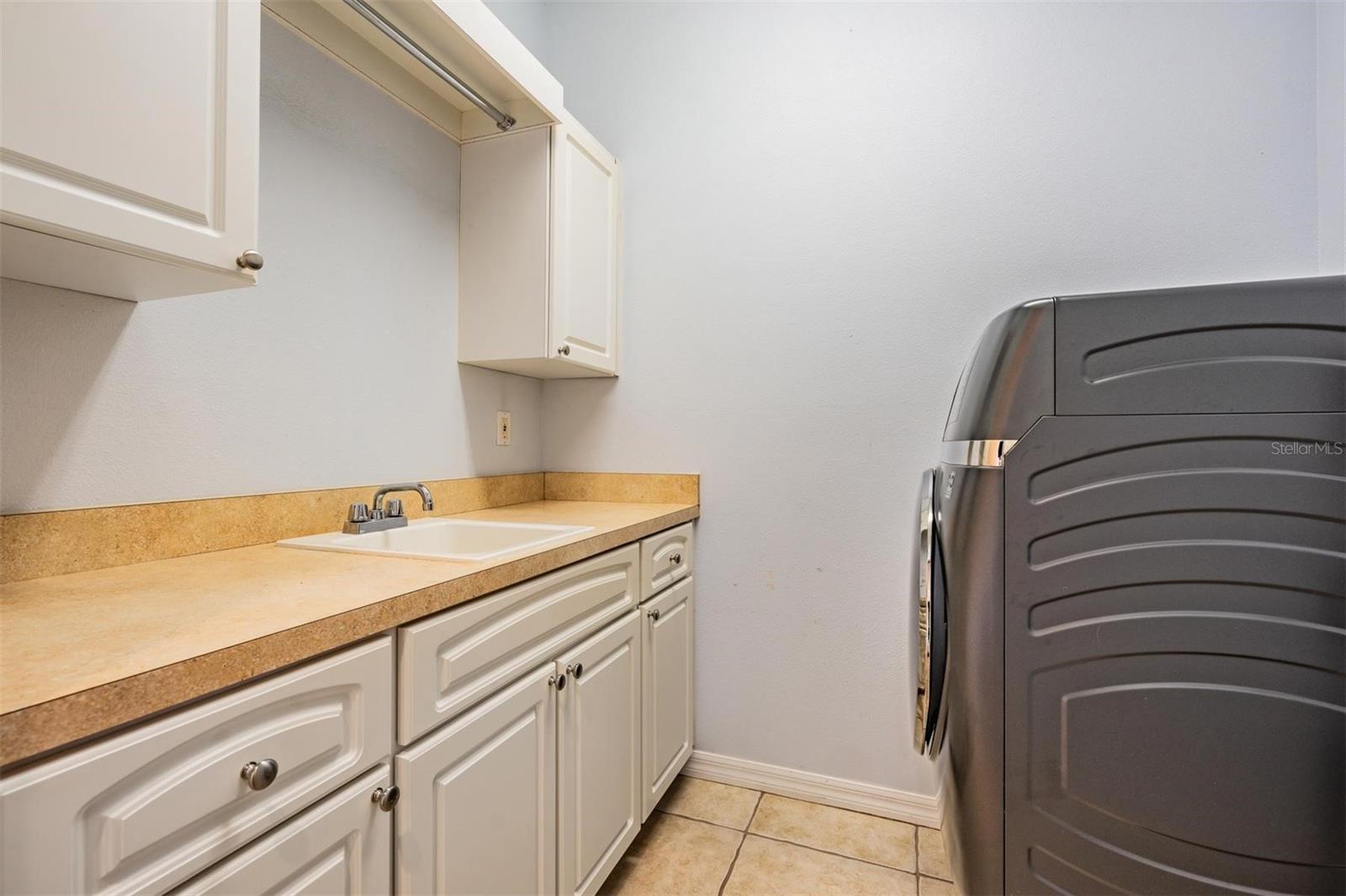 Laundry offers cabinets and sink (machines do not convey)
