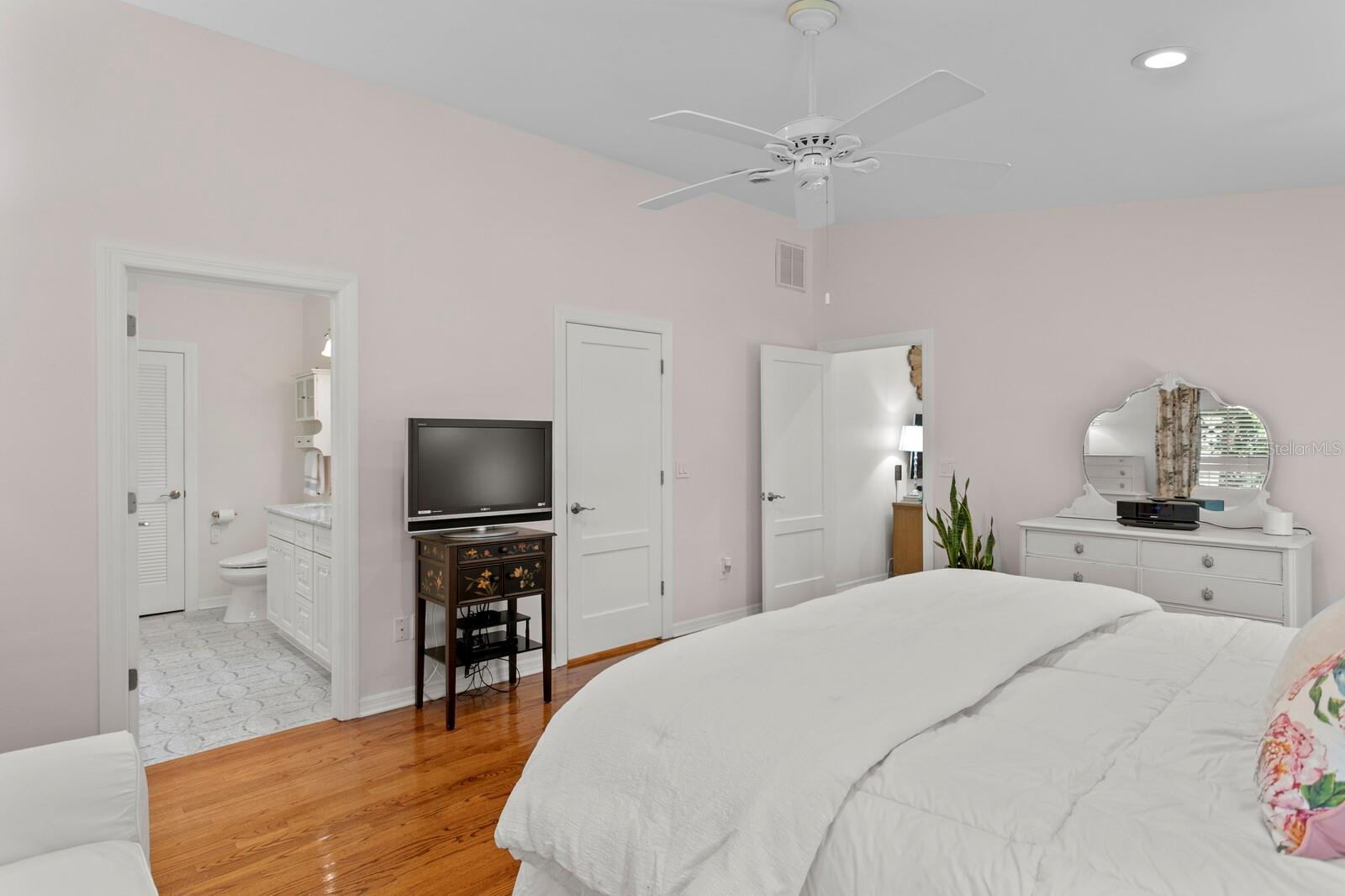 primary bedroom with a walk in closet next to the tv on the right and your bathroom oasis.