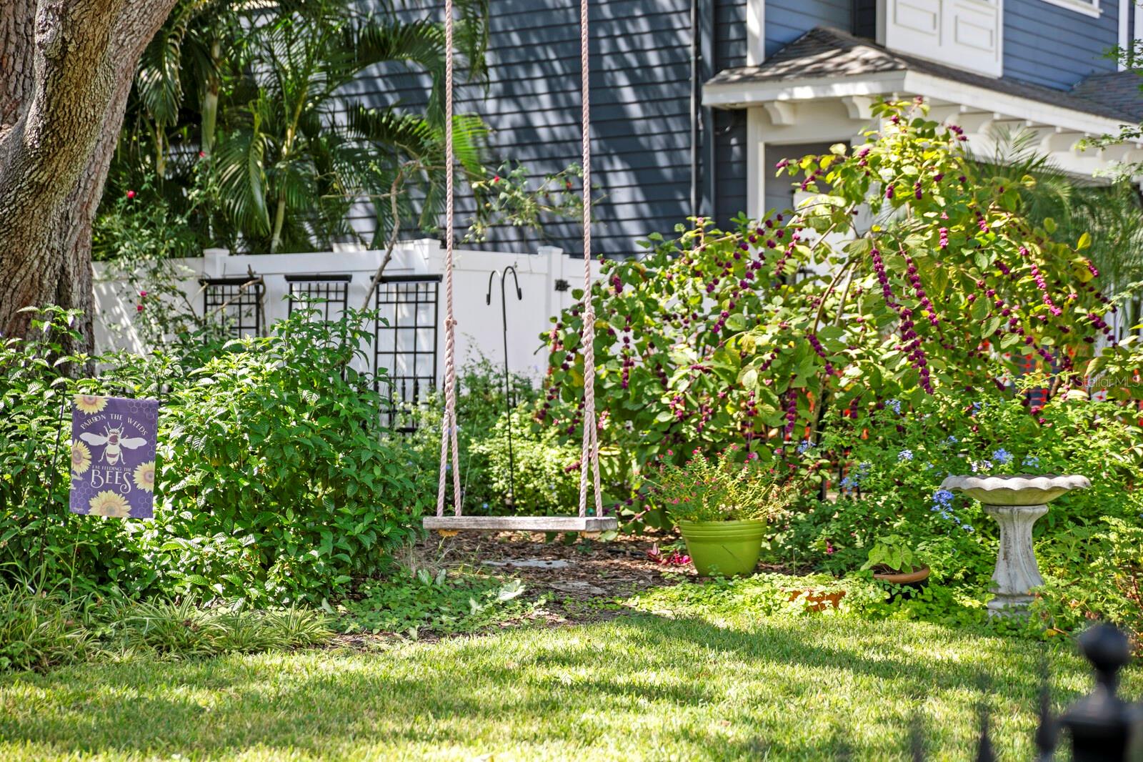Charming swing in the front yard with all the upgrades for wildlife to hang out.