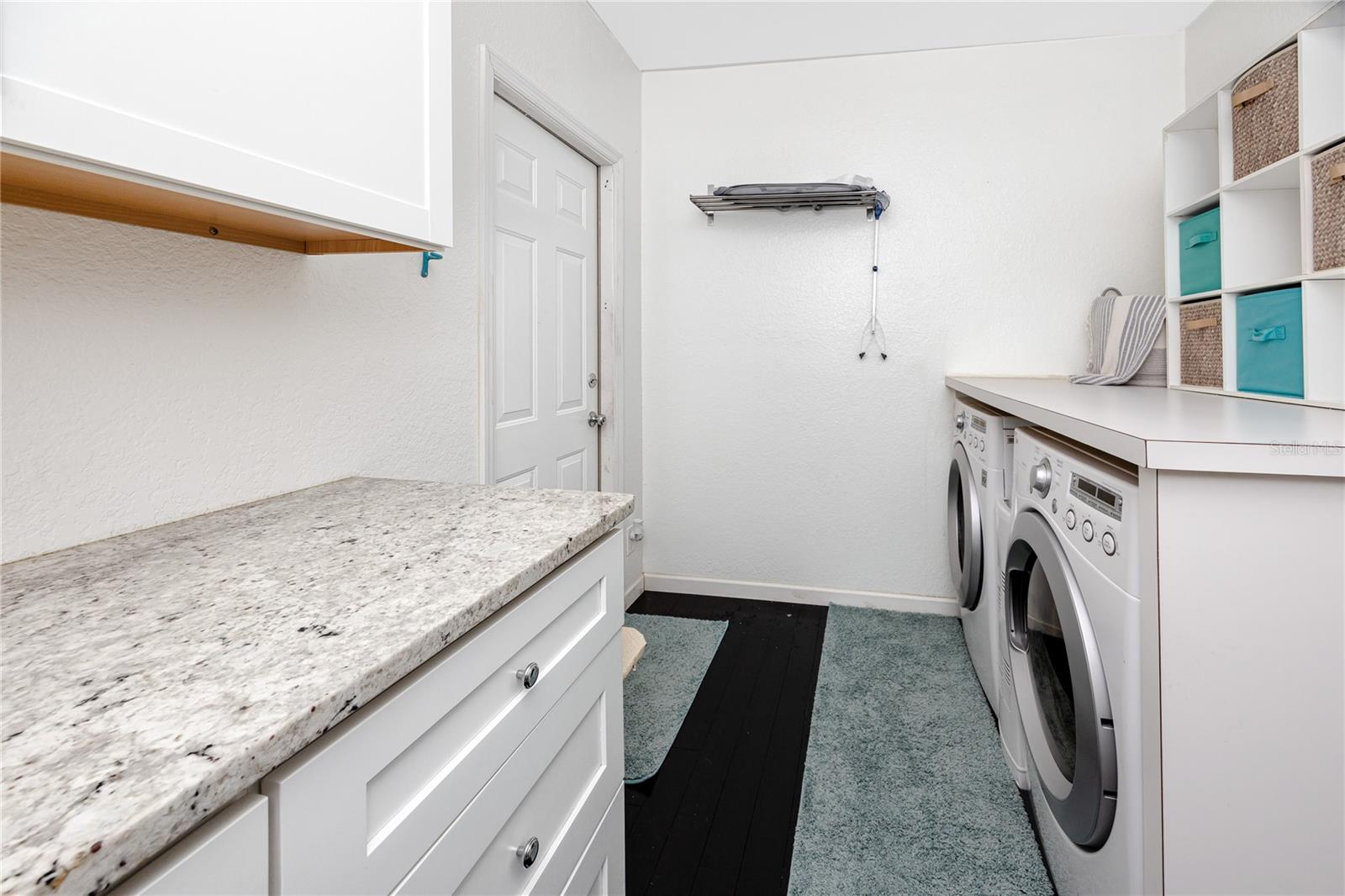 Dedicated indoor laundry room with additional storage and access to the 2 car garage.